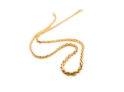a close up of a gold necklace on a white background