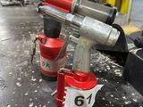 two air tools on a table in a workshop