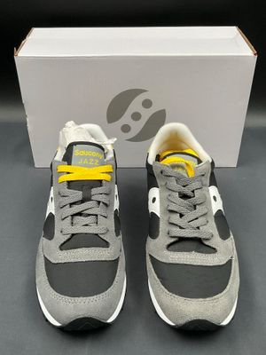a pair of grey and yellow sneakers with yellow laces
