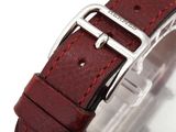 a close up of a watch with a red leather strap
