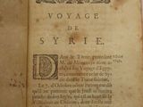 an old book with writing on it sitting on a table