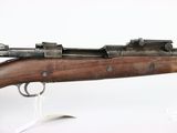 an old rifle with a wooden barrel and metal sights