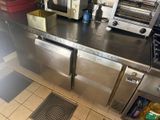 stainless steel counter top in a commercial kitchen with a toaster oven
