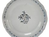 a blue and white plate with a decorative design on it