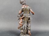 bronze statue of a woman holding a child on a marble base