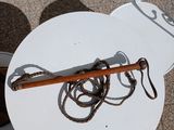 a white plate with a wooden handle and a rope on it