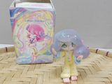 a small figurine sitting next to a box on a table