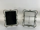 two picture frames that are sitting on a table