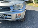 a silver toyota rav parked on the side of the road