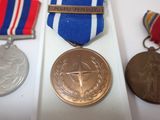 three medals and a medal on display on a table