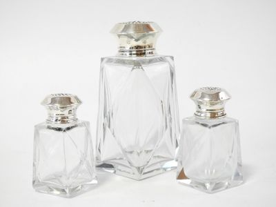 three pieces of glass with a silver top and a silver base