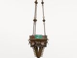 an antique brass hanging lamp with a green glass shade