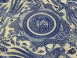 a blue and white plate with birds and flowers on it
