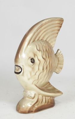 a ceramic fish figurine sitting on a white surface