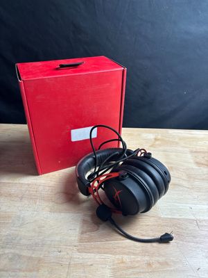 an image of a pair of headphones sitting on top of a wooden table