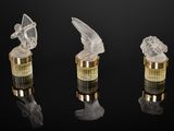 three crystal angel figurines on a black background