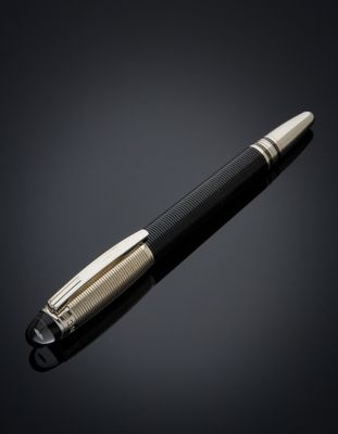 a black and gold pen on a black background