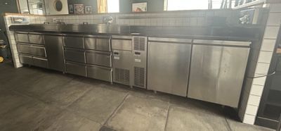 a large stainless steel kitchen with a lot of counter space