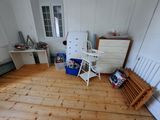 a room with a bed, a dresser, a chair, and a chest of drawers