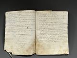 an old book with writing on it sitting on top of a table