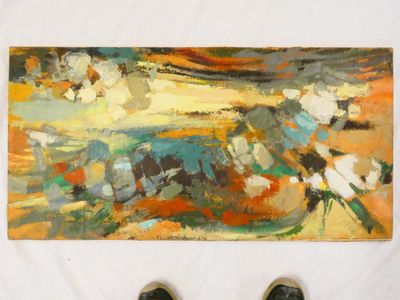 someone standing in front of a painting with their feet on the ground