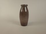 a brown vase that is sitting on a table