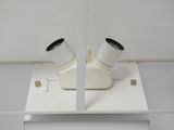 a picture of a white toilet with two toilet paper dispensers on top of it