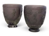 deux vases posés l'un à côté de l'autre sur une surface blanche