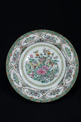 an image of a plate with flowers on it on a black background