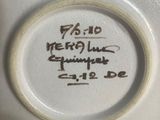 a close up of a white plate with writing on it