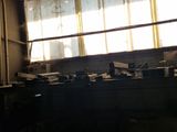 sunlight shining through a window in a rundown building filled with junk