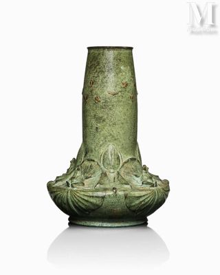 a green vase that is sitting on a white surface