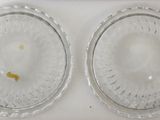 two clear glass plates with a yellow object in the middle of them
