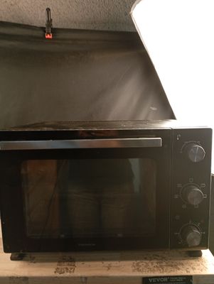 a microwave oven sitting on top of a wooden table