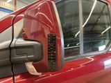 a red truck with a measuring tape on the side of it ' s door