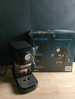 an image of a coffee maker sitting on top of a wooden table
