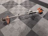 a man using a string trimmer to trim a floor