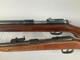 a close up of a rifle on display on a white surface
