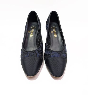 pair of women ' s black shoes on a white surface