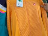 a person holding a jacket on a rack in a store