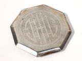 a small silver plate with a design on it