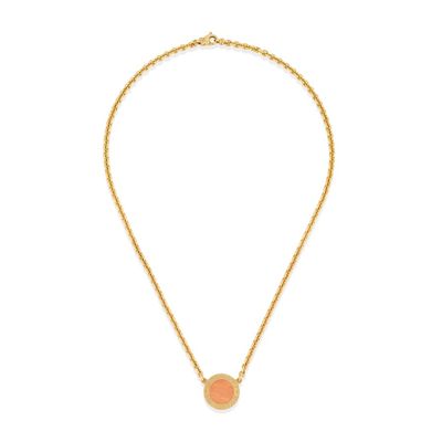 a gold necklace with an orange stone pendant on a gold chain