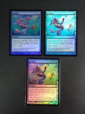 three cards with different designs on them sitting on a table