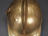 a gold helmet that is sitting on a table
