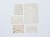 plusieurs feuilles de papier sur lesquelles sont inscrits des caractères, posées sur une surface blanche