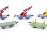 four different types of toy trains on a white surface