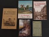 Plusieurs livres sont posés sur une table recouverte d'une nappe noire.
