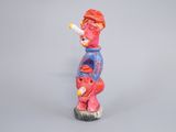 figurine of a man with a cigarette in his mouth on a gray background