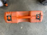 an orange tool case sitting on the floor next to a pair of shoes