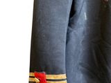 the back of a military uniform with a red and gold stripe